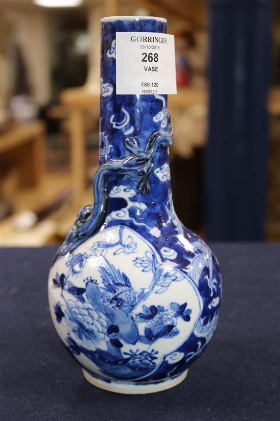 A blue and white vase painted with dragons and birds